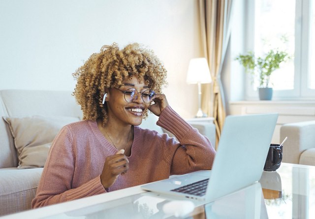 Woman Listening to Music and Working on Computer | Blog | Greystar