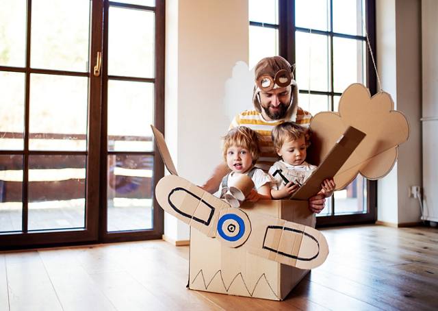 Dad playing with his two children with a DIY airplane | Blog | Greystar