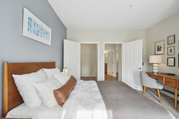 Modern bedroom with natural light and stylish decor at Jefferson at Dedham Station Apartments