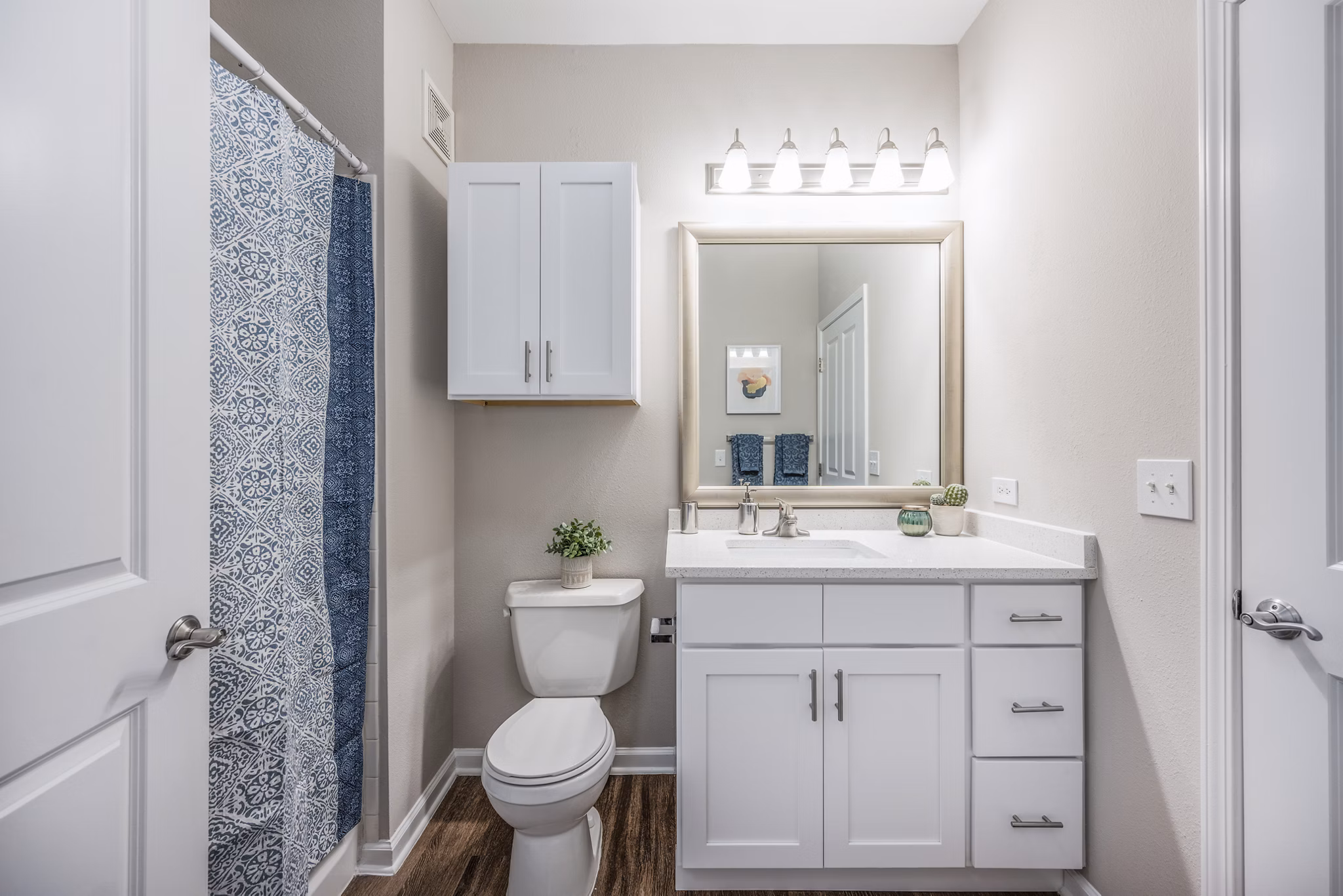 Bathroom with modern fixtures and sleek tile in Jefferson at Dedham Station Apartments, a luxury property offering comfort and style
