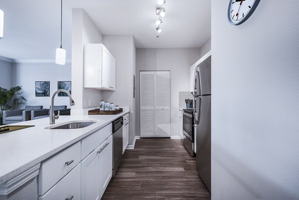 Modern kitchen with stainless steel appliances at Jefferson at Dedham Station Apartments