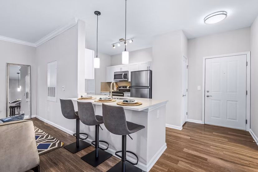 Contemporary entryway and kitchen with sleek countertops in Jefferson at Dedham Station Apartments