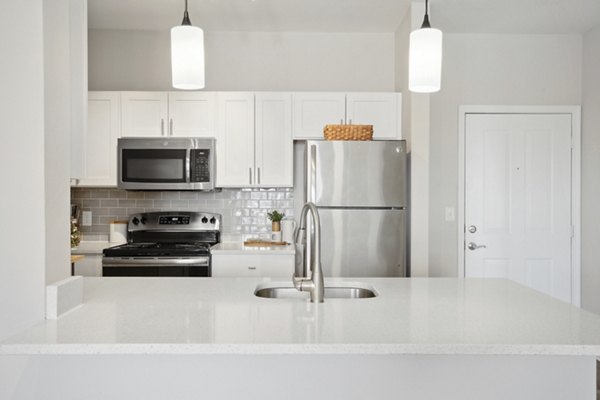 Modern kitchen with stainless steel appliances in Jefferson at Dedham Station Apartments