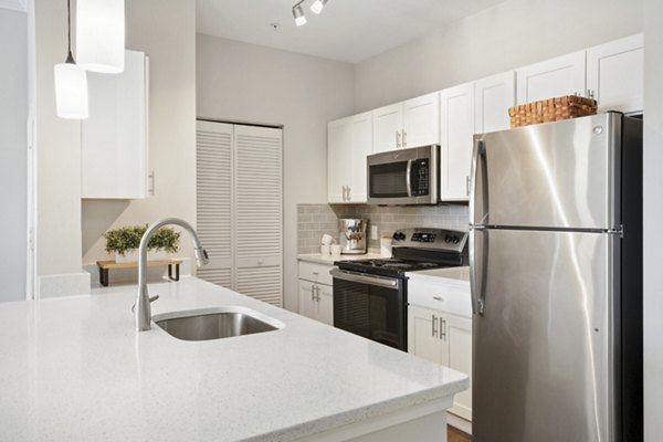 Modern kitchen with stainless steel appliances in Jefferson at Dedham Station Apartments