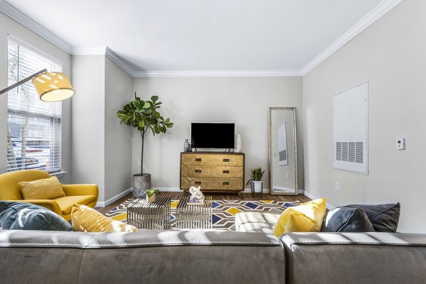 Spacious living room featuring stylish decor at Jefferson at Dedham Station Apartments