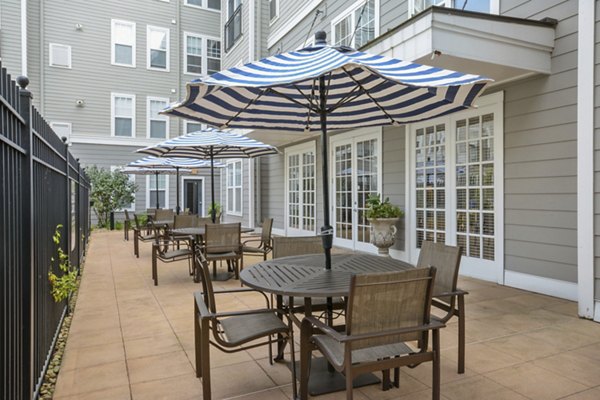 Relaxing patio with modern seating at Jefferson at Dedham Station Apartments, perfect for outdoor gatherings and leisure activities