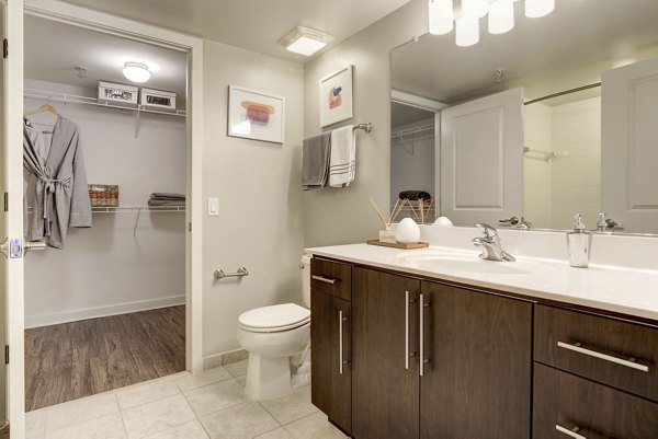 Bathroom with sleek fixtures and marble accents at 100 Capitol Yards Apartments