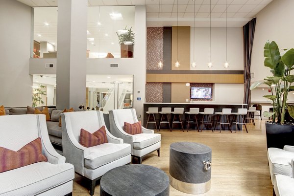 Inviting clubhouse featuring modern seating and entertainment options at 100 Capitol Yards Apartments