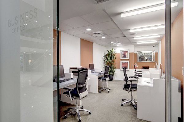 Modern business center with computer stations at 100 Capitol Yards Apartments