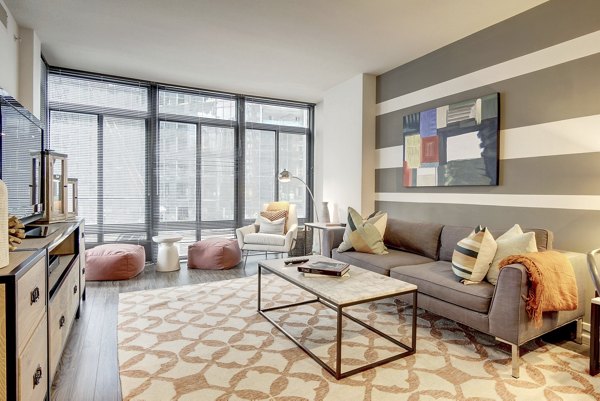 Living room with modern decor and ample natural light at 100 Capitol Yards Apartments, luxury residences in an urban setting