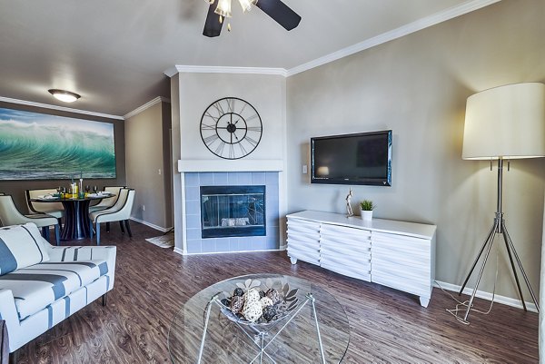 Spacious living room with modern dÃ©cor and large windows at Monte Vista Apartments