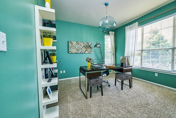 Home office with modern furnishings in Monte Vista Apartments offering a stylish workspace for remote professionals in a luxury setting