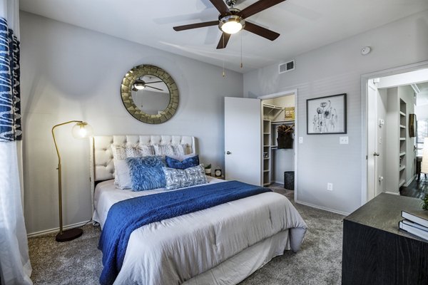 Cozy bedroom featuring modern decor and large windows at Hardrock Canyon Apartments