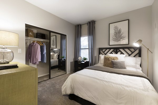 Elegant bedroom with natural light at Hardrock Canyon Apartments, offering luxury living in the heart of Austin