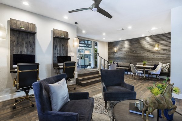 Business center with modern workstations at Hardrock Canyon Apartments, offering a productive space for residents