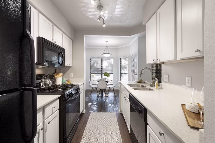 Modern kitchen with sleek countertops and stainless steel appliances in Hardrock Canyon Apartments