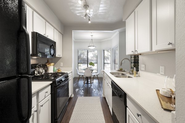 Modern kitchen with sleek countertops and stainless steel appliances in Hardrock Canyon Apartments