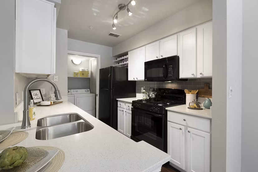Modern kitchen with stainless steel appliances in Hardrock Canyon Apartments, perfect for luxury living