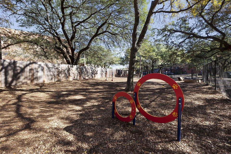 Expansive outdoor dog park at Hardrock Canyon Apartments featuring agility equipment and open play areas