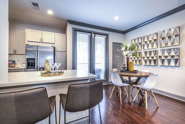 Dining room with modern decor at Manchester State Thomas Apartments in the heart of the city, offering a luxurious living experience