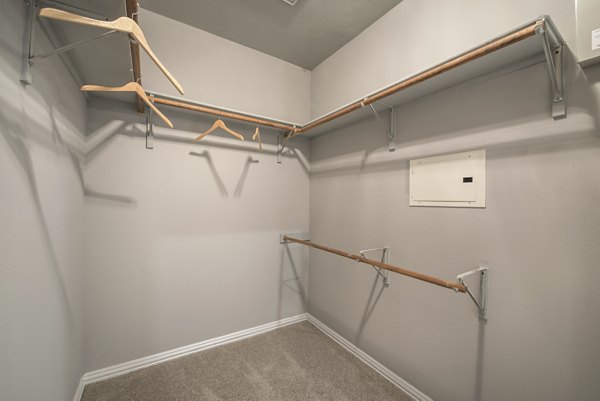 Modern walk-in closet with ample shelving and storage solutions at Manchester State Thomas Apartments