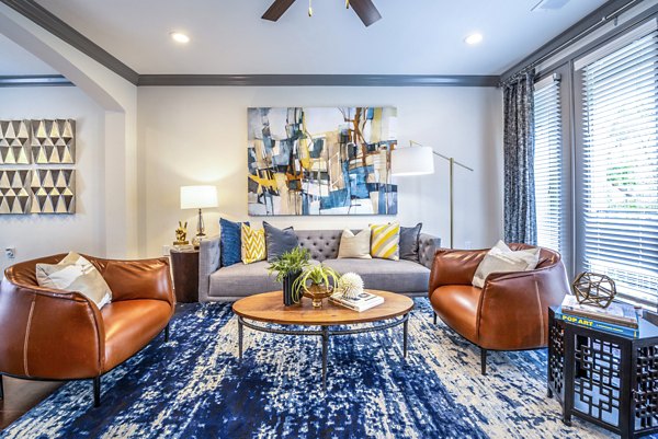 Inviting living room with modern decor and natural light at Manchester State Thomas Luxury Apartments