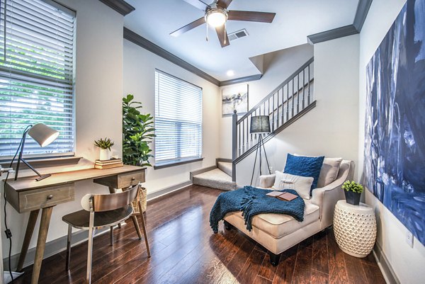 Home office with stylish furnishings and a modern stairway at Manchester State Thomas Apartments