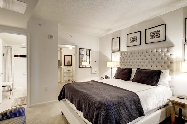 Bedroom featuring modern decor and large windows at 70 Capitol Yards Apartments