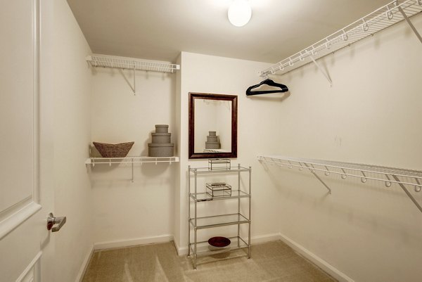 Spacious walk-in closet with built-in shelving in 70 Capitol Yards Apartments luxury unit