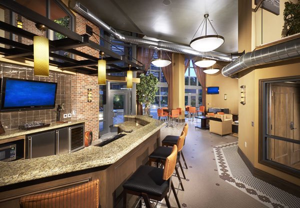 Clubhouse with modern design at 70 Capitol Yards Apartments, featuring cozy seating and entertainment spaces