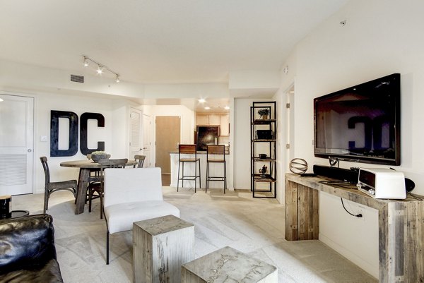 Living room with stylish furniture and large windows at 70 Capitol Yards Apartments, luxury living in a prime location