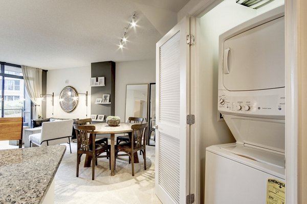 Laundry room featuring high-efficiency washers and dryers at 70 Capitol Yards Apartments
