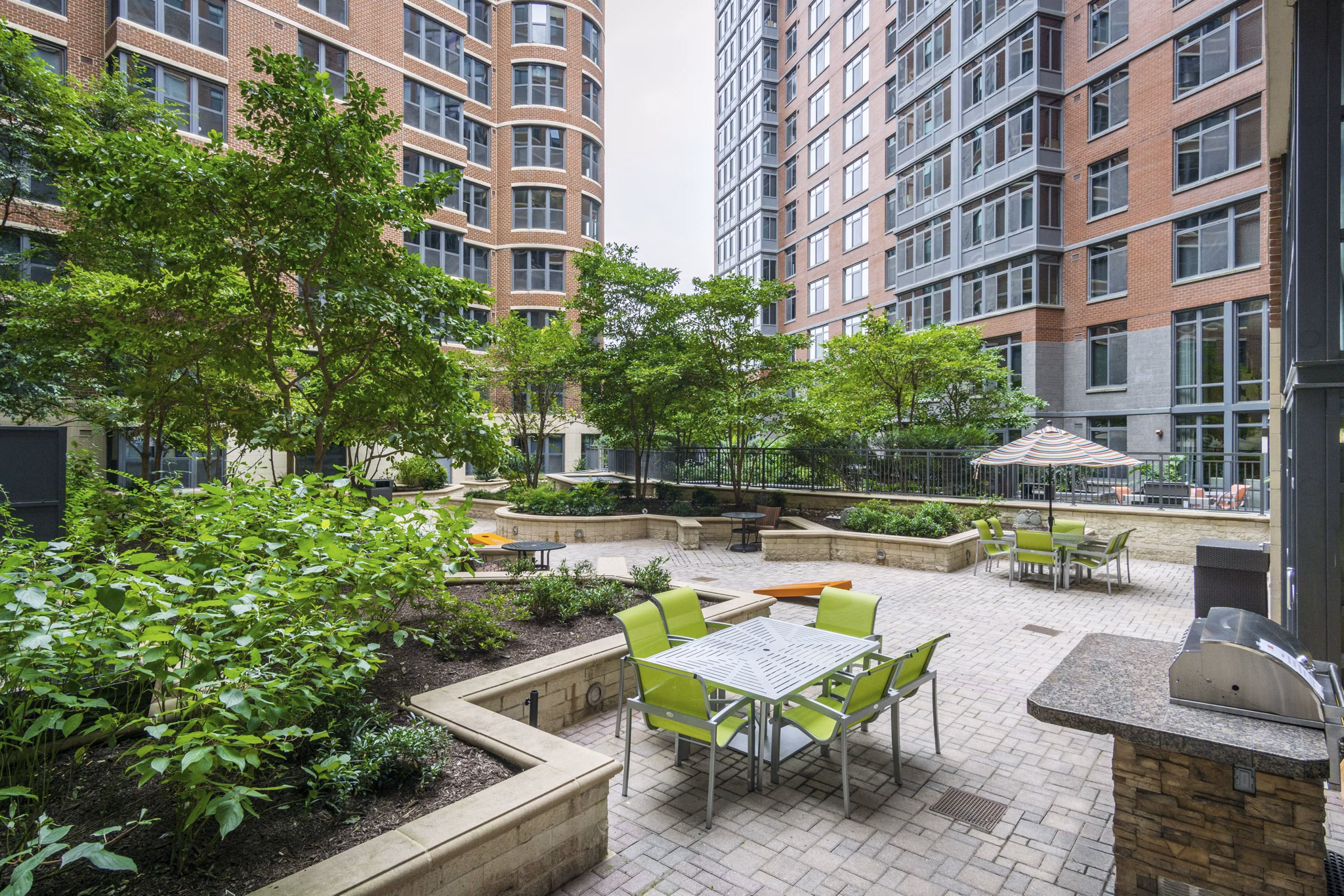 Courtyard featuring lush greenery and seating areas at 70 Capitol Yards Apartments