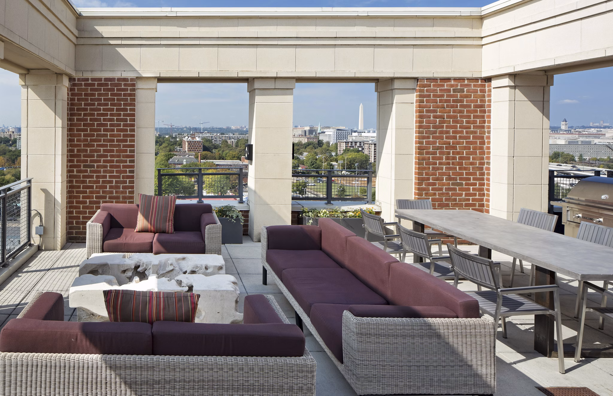 Spacious rooftop deck with lounge seating at 70 Capitol Yards Apartments offering views of the city skyline