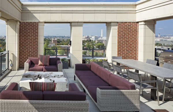 Spacious rooftop deck with lounge seating at 70 Capitol Yards Apartments offering views of the city skyline