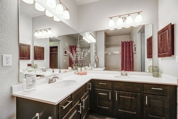 Bathroom featuring sleek countertops and modern fixtures at Creekside at Highlands Ranch Apartments