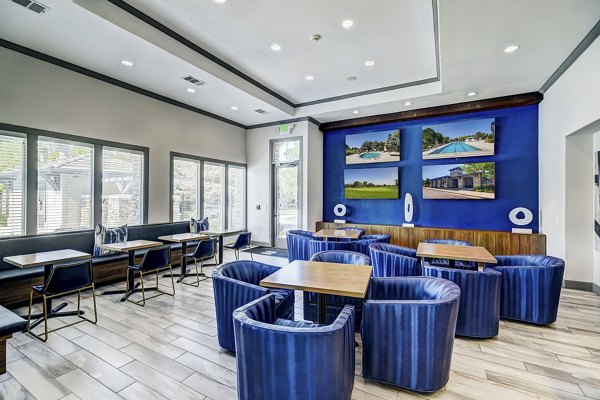 Clubhouse featuring modern design and cozy seating at Creekside at Highlands Ranch Apartments