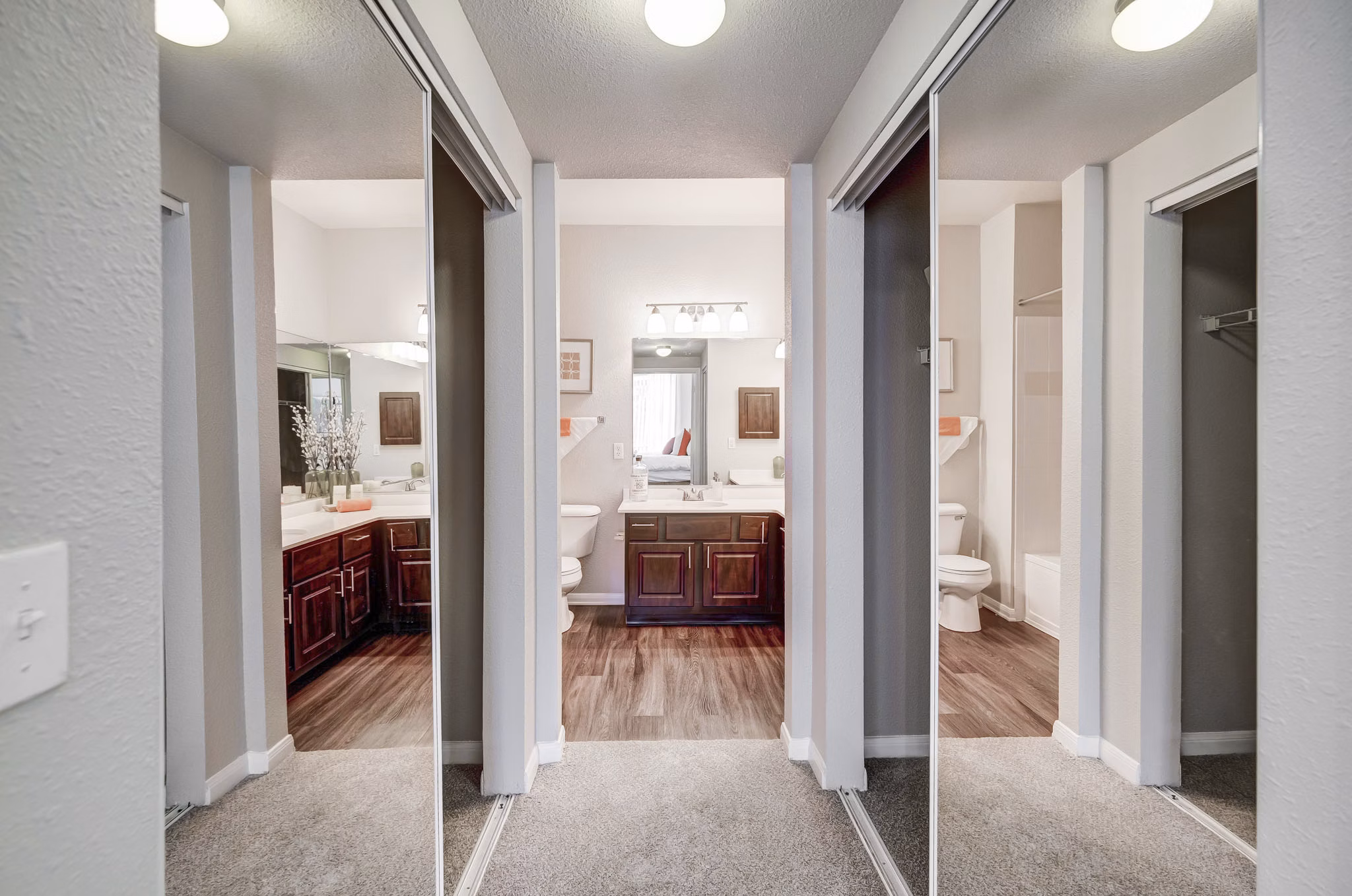 Wide hallway with modern lighting and artwork at Creekside at Highlands Ranch Apartments