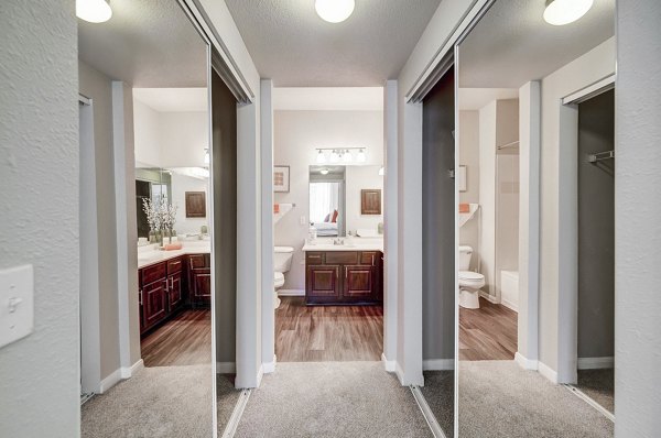 Wide hallway with modern lighting and artwork at Creekside at Highlands Ranch Apartments
