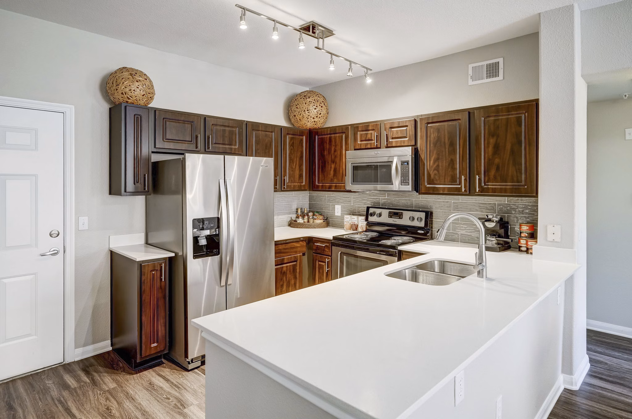 Modern kitchen with stainless steel appliances at Creekside at Highlands Ranch Apartments