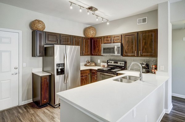 Modern kitchen with stainless steel appliances at Creekside at Highlands Ranch Apartments