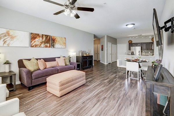 Living room with stylish furnishings and natural light at Creekside at Highlands Ranch Apartments, a luxury Greystar property