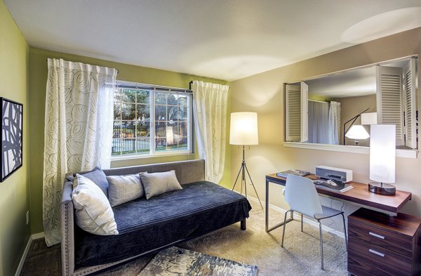Elegant bedroom with large windows and modern decor in Bay Court at Harbour Pointe Apartments, ideal for luxury living