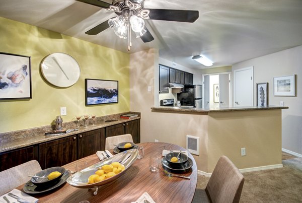 Dining room with elegant hardwood floors and modern lighting at Bay Court at Harbour Pointe Apartments