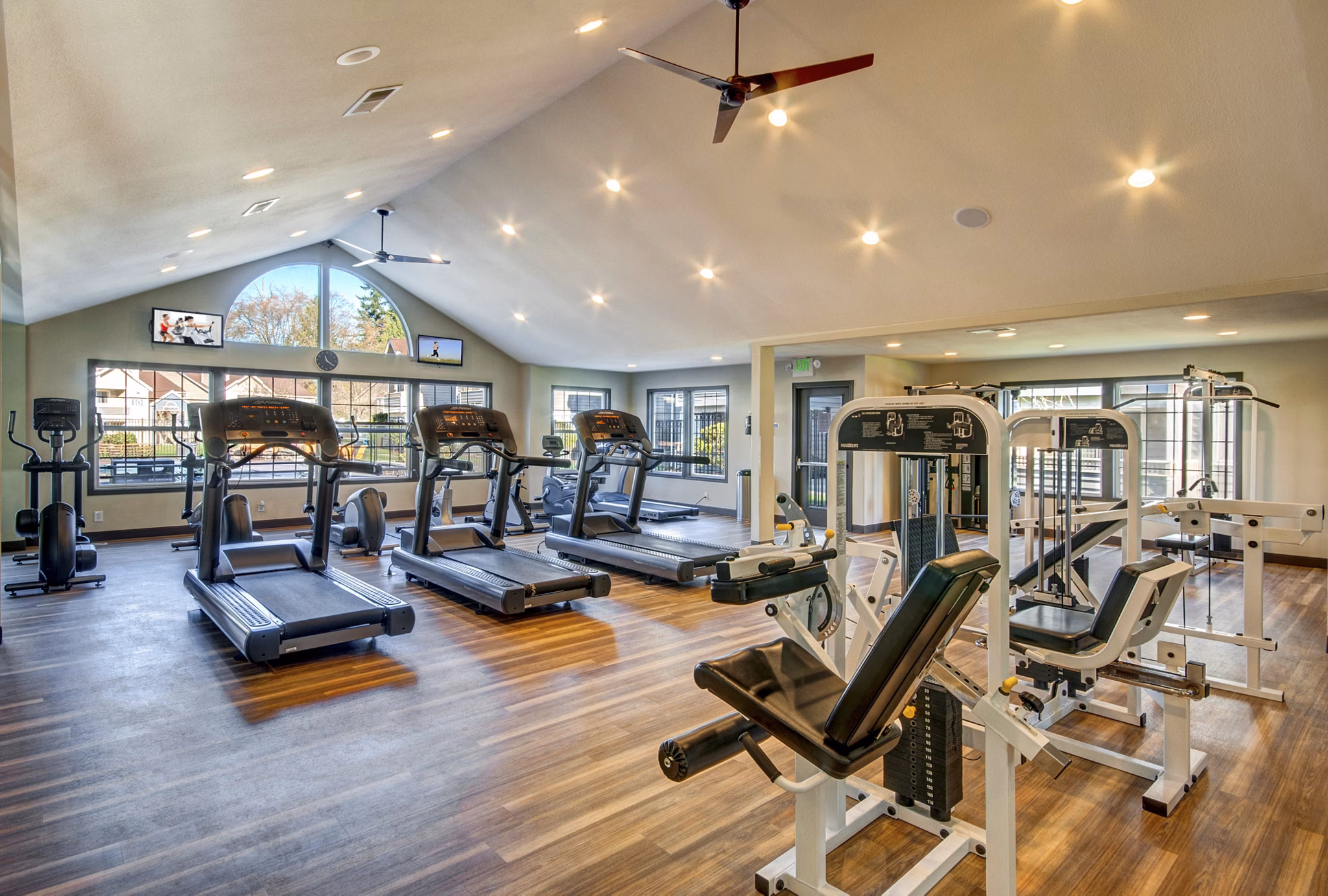 Modern fitness center with state-of-the-art equipment at Bay Court at Harbour Pointe Apartments, offering residents a superior workout experience