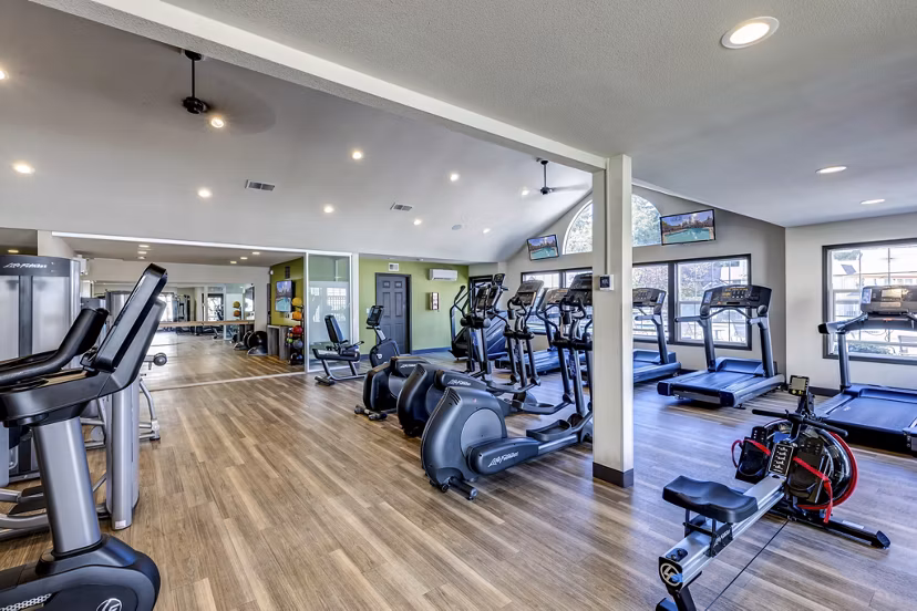 Modern fitness center with cardio machines at Bay Court at Harbour Pointe Apartments