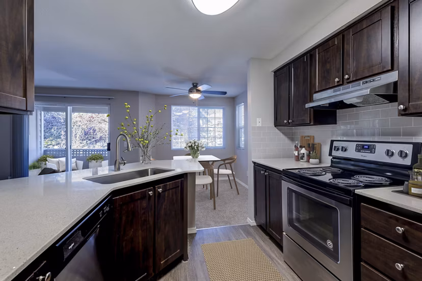 Modern kitchen with stainless steel appliances at Bay Court at Harbour Pointe Apartments