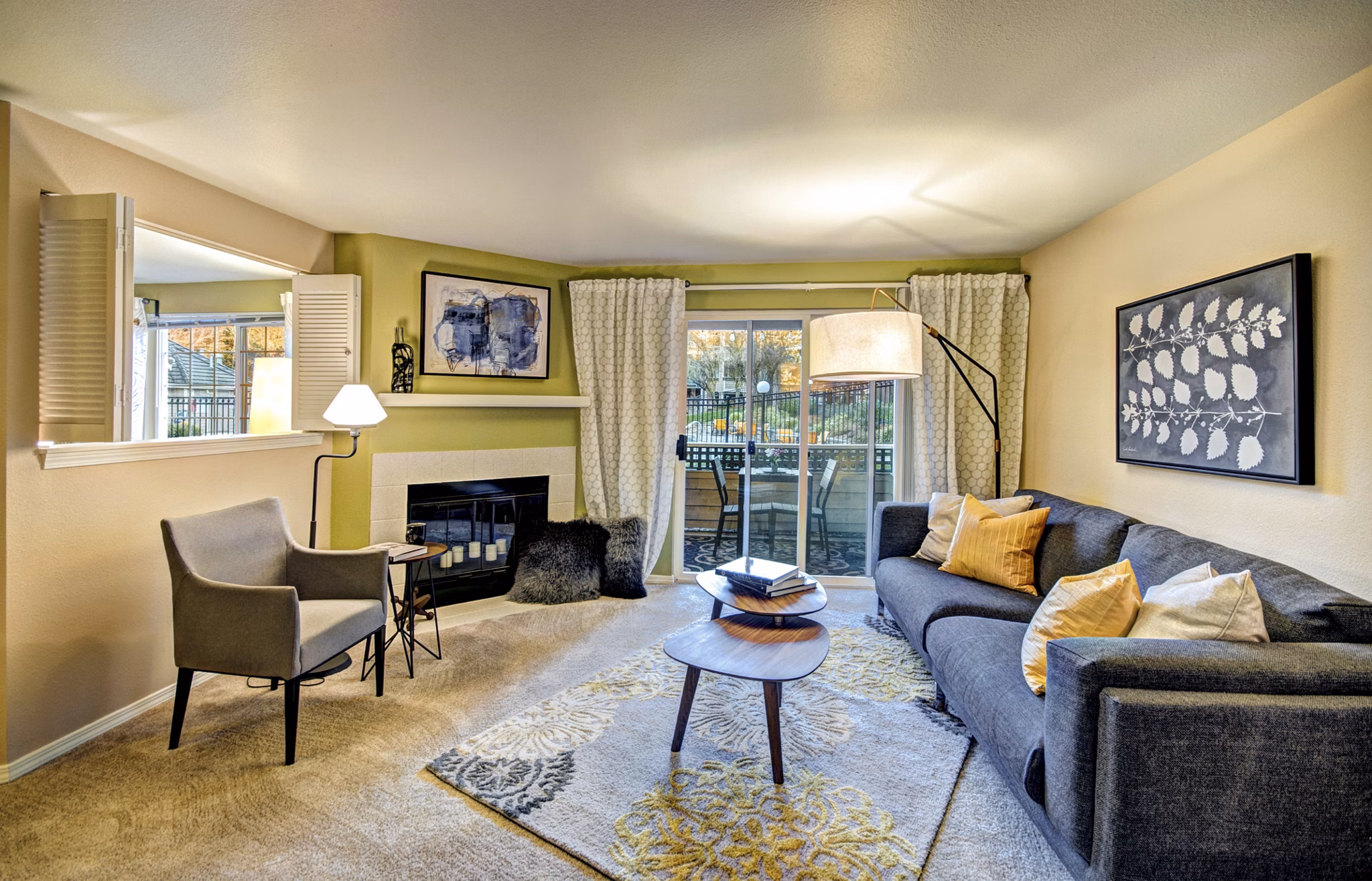 Spacious living room with modern decor and large windows in Bay Court at Harbour Pointe Apartments