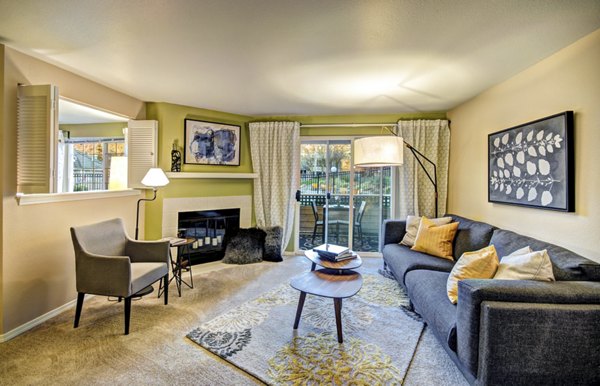 Spacious living room with modern decor and large windows in Bay Court at Harbour Pointe Apartments