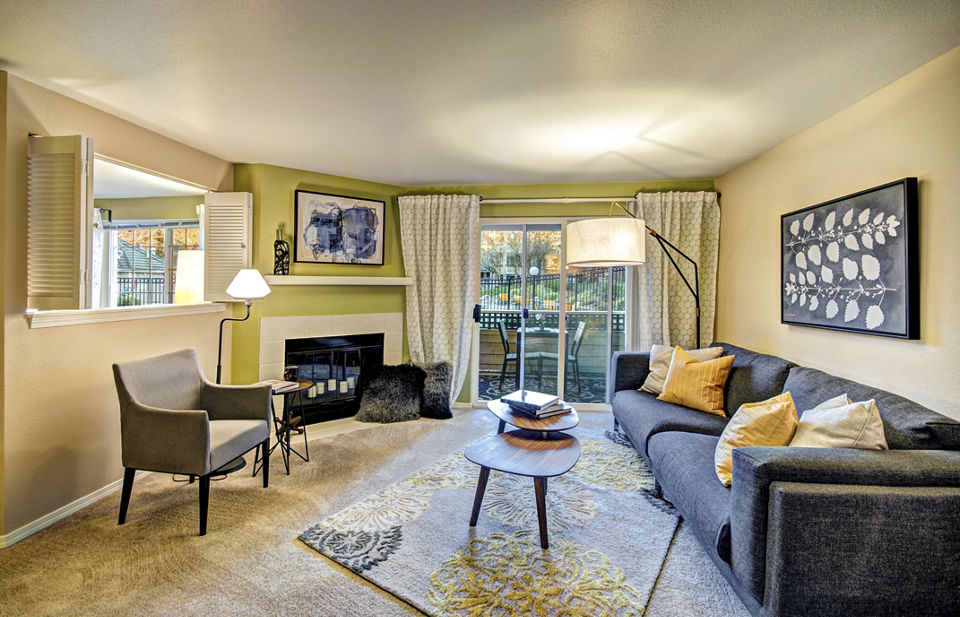 Spacious living room with modern decor and large windows in Bay Court at Harbour Pointe Apartments